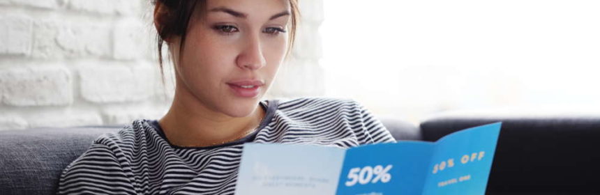 woman reading brochure print media