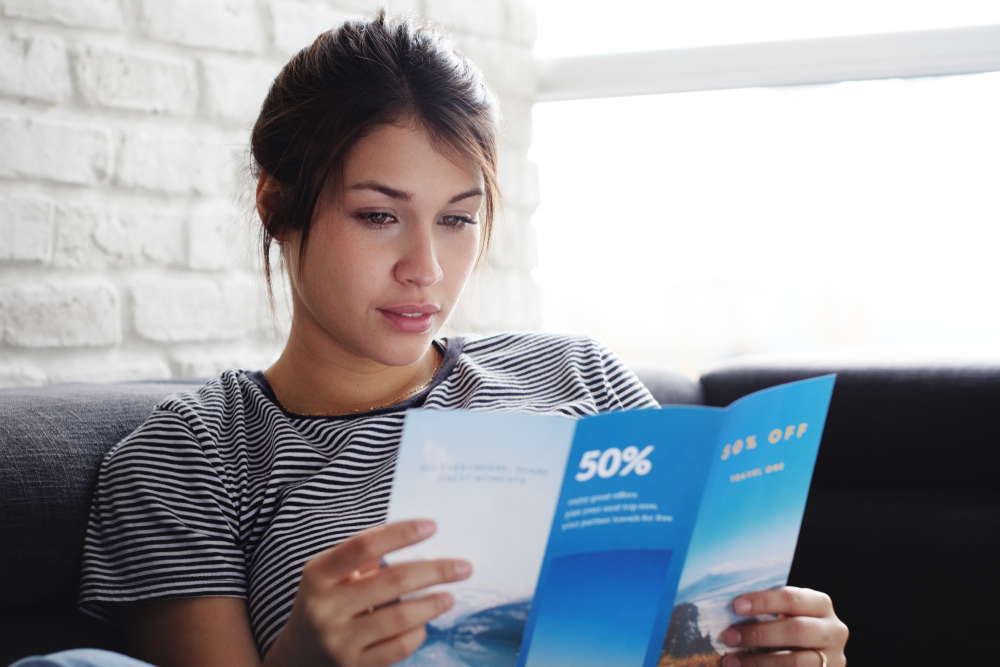 woman reading brochure print media 