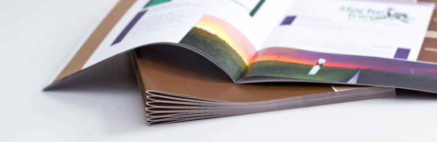 A magazine laying open on a table featuring different print media.