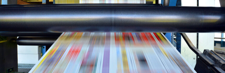 Newspaper ads running through a printer