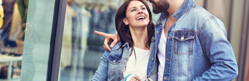 A happy couple out shopping together on a sunny day